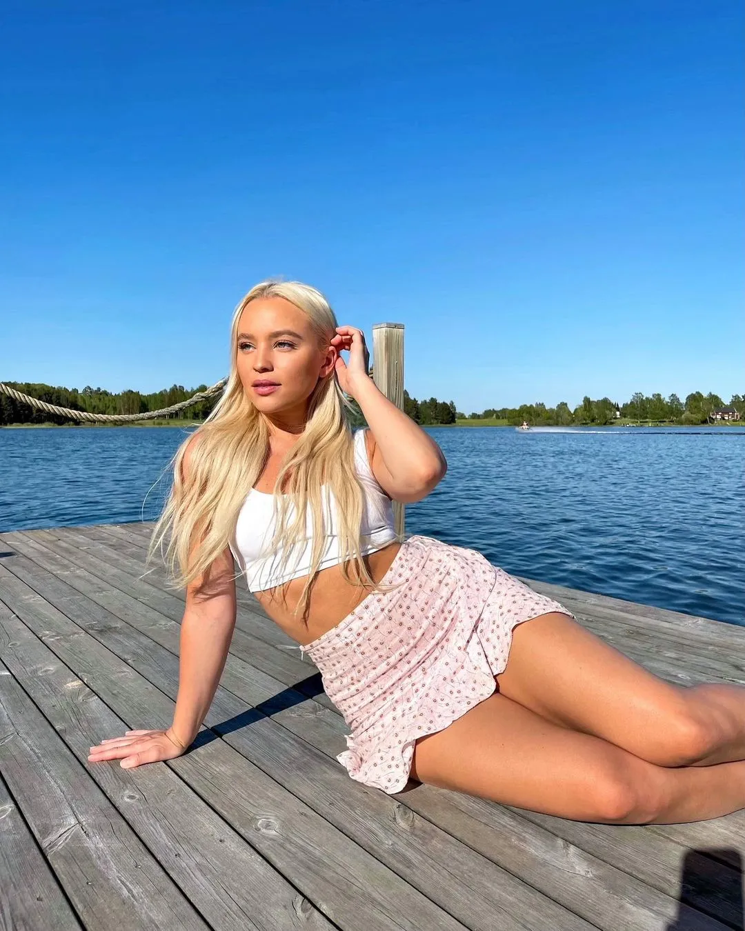 Woman sitting on a dock looking over the camera